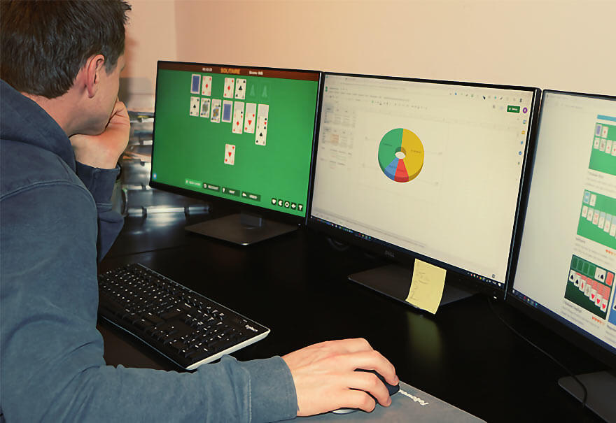 An office worker plays the card game Solitaire during work hours