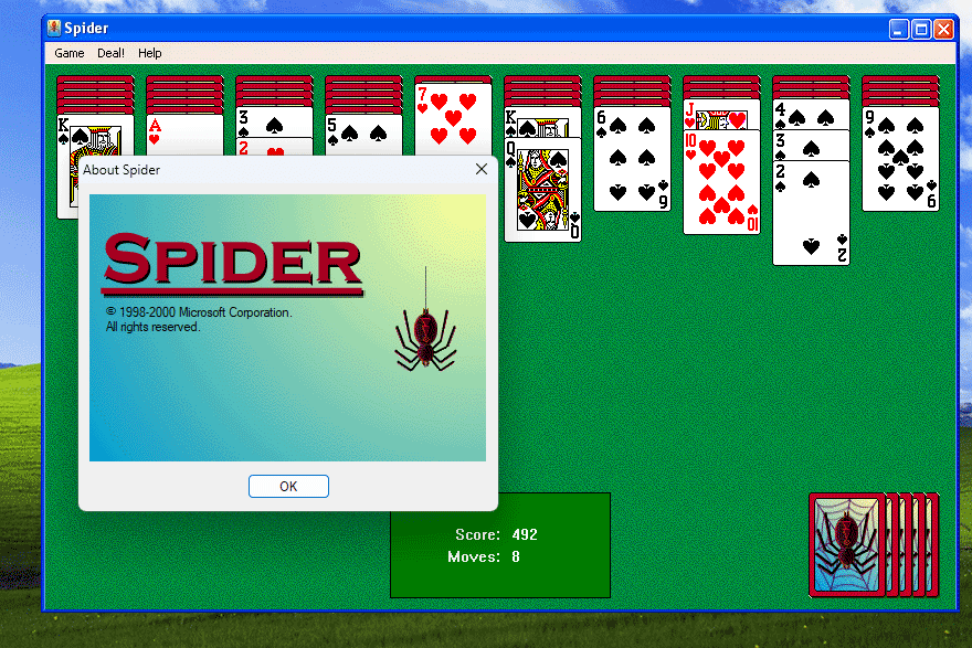 Spider Solitaire on Windows XP with About screen and game interface